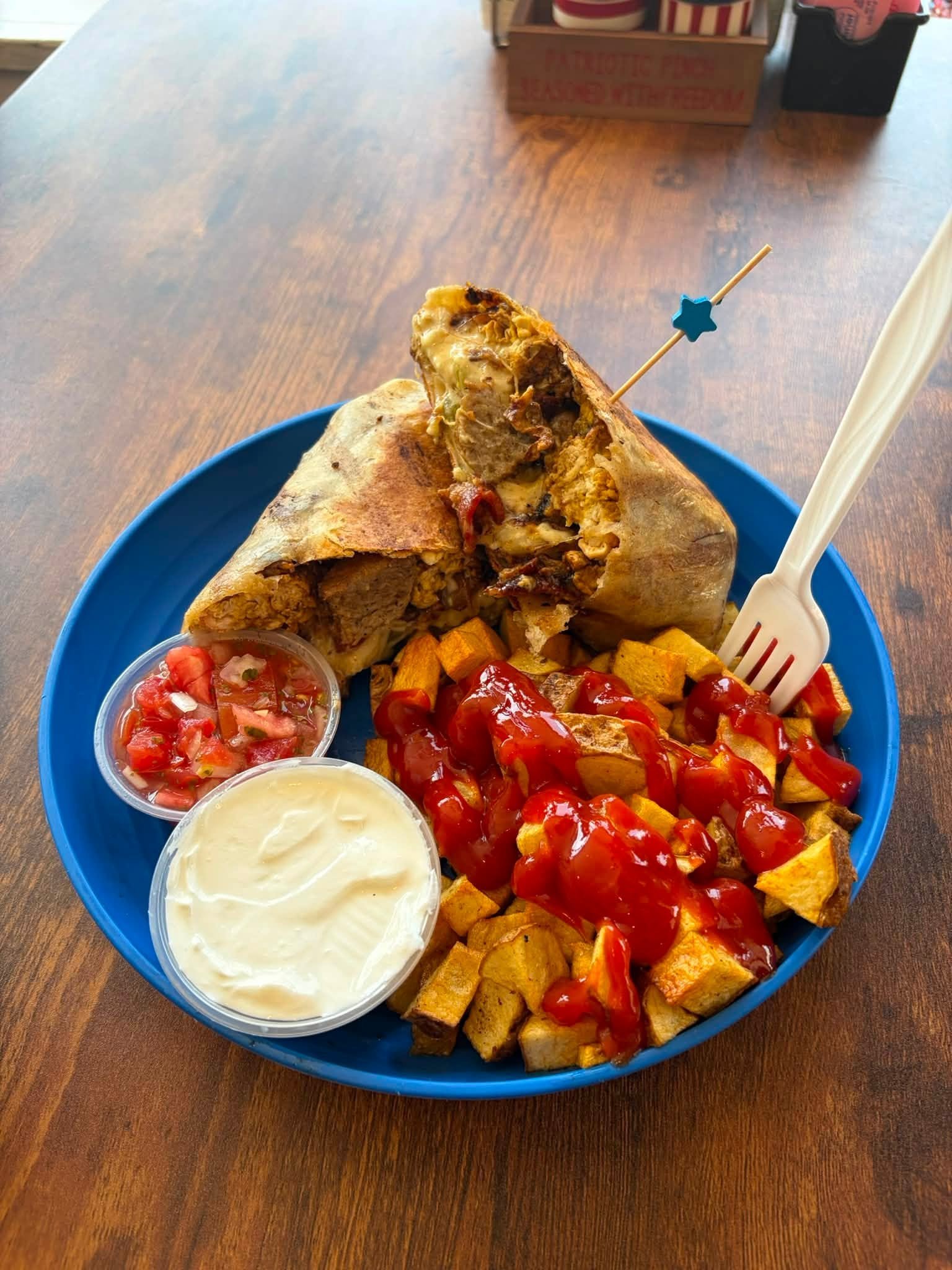 Breakfast quesadilla, street tacos, tater tots and drinks on the table