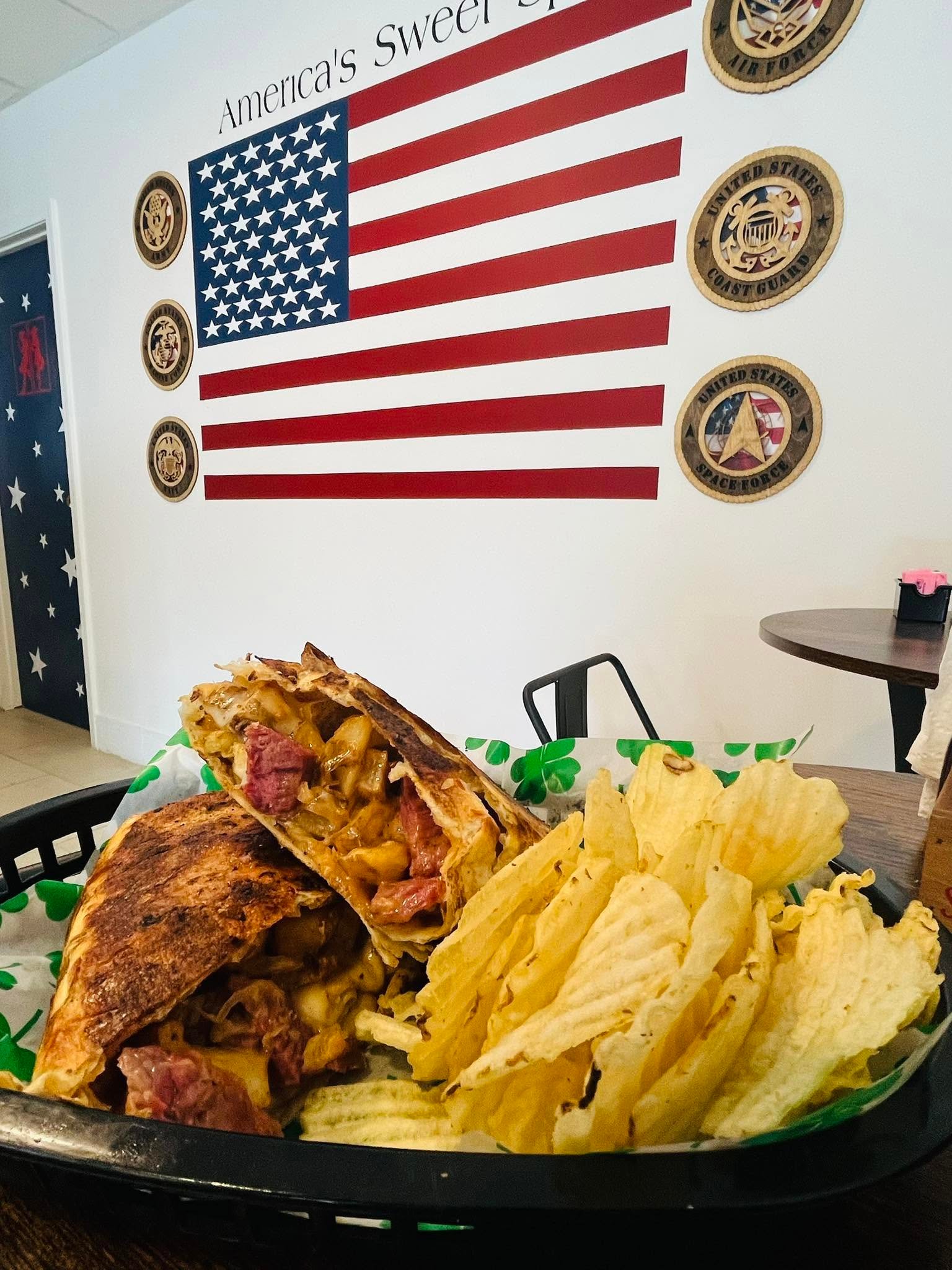 Grilled wrap sandwich sliced in half in front of American flag wall